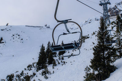 Overhead cable car against sky during winter