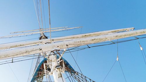 Low angle view of sailboat against clear blue sky