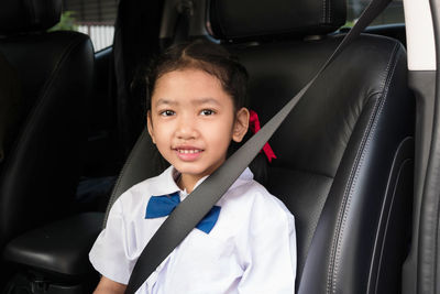 Portrait of smiling boy in car