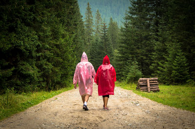 Rear view of woman walking on footpath