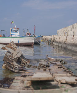 Boats moored on beach against sky