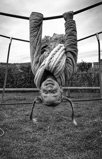 Portrait of smiling girl in park against sky