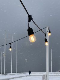 Person walking on street light during winter