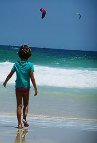 Rear view of boy on beach