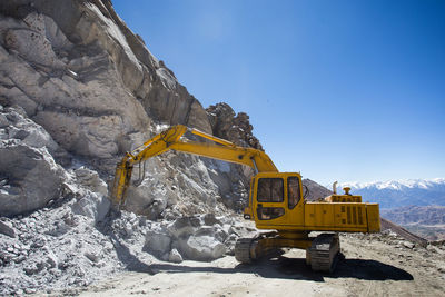 Low angle view of yellow construction site against sky