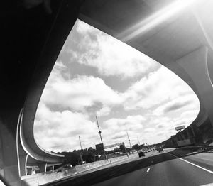 Low angle view of bridge in city against sky