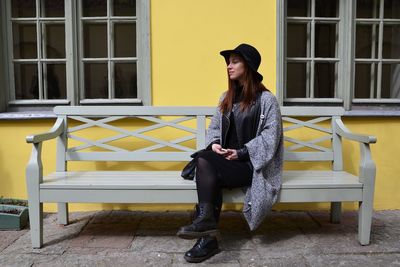 Full length of woman standing on railing