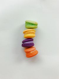 Close-up of multi colored candies against white background