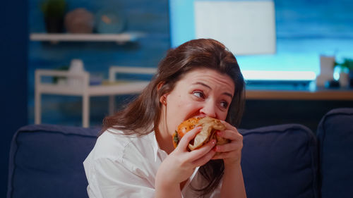 Portrait of young woman eating food