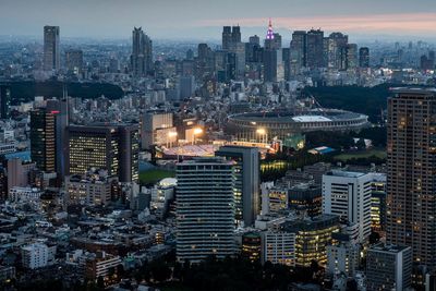 High angle view of illuminated city buildings against sky