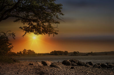 Scenic view of rocks against sky during sunset