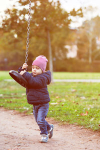 Boy playing at playground during winter