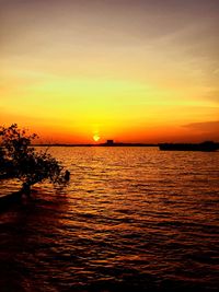 Scenic view of sea against romantic sky at sunset