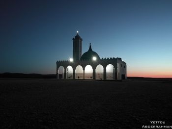 Illuminated building against sky at night