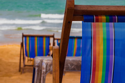 Empty chairs and table at beach