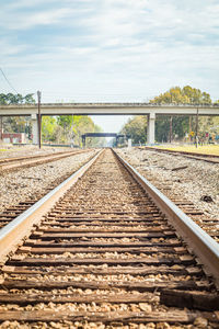 Surface level of railroad tracks against sky