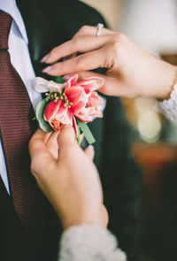 Midsection of woman holding flowers