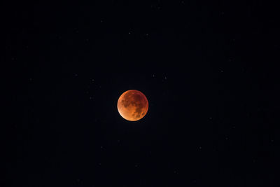 Low angle view of full moon against sky