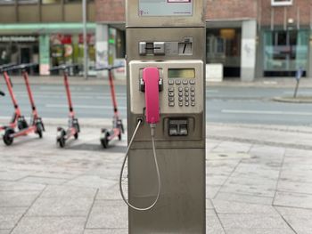 Close-up of telephone booth on sidewalk