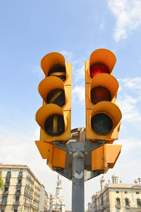 Low angle view of road signal against sky