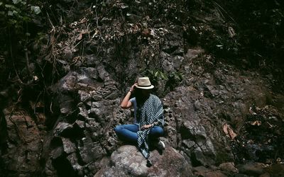 Woman sitting on rock