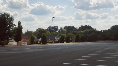 Empty road along trees