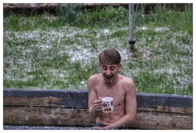 Portrait of shirtless man in snow