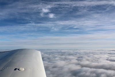 Aerial view of cloudscape over airplane wing