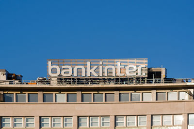 Low angle view of building against clear blue sky