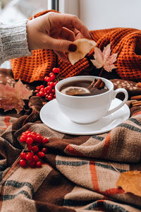 Midsection of coffee cup on table