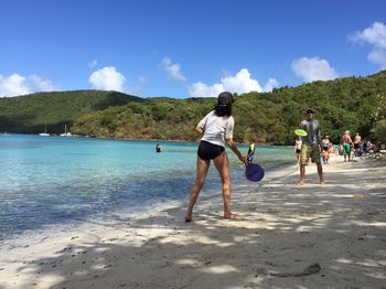 People on beach against sky