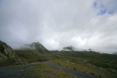 Scenic view of mountains against cloudy sky