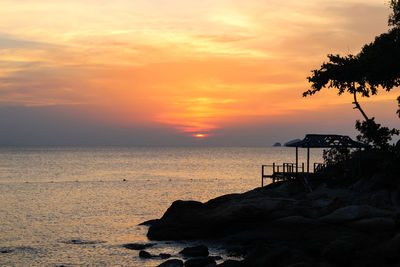 Scenic view of sea against orange sky