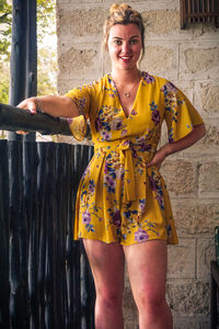 Portrait of smiling young woman standing outdoors