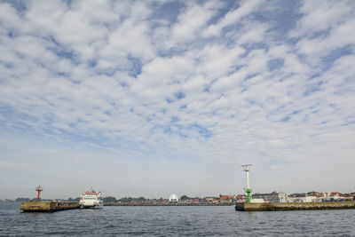 Ship sailing in sea against sky