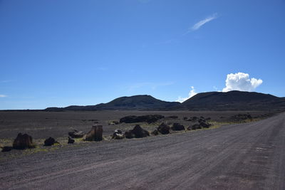 Scenic view of desert road against sky