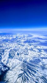 Aerial view of landscape against blue sky