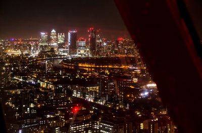 High angle view of illuminated buildings in city at night