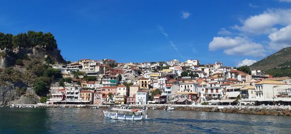 Townscape by sea against sky in town