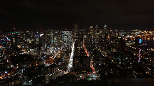 High angle view of illuminated city buildings at night