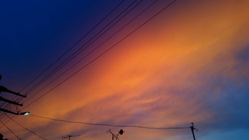 Low angle view of electricity pylon against sky