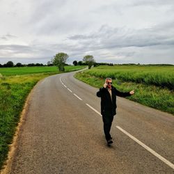 Full length of a man standing on road