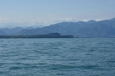 Scenic view of sea and mountains against sky