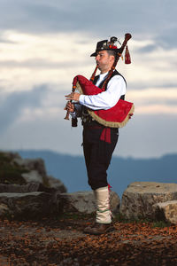 Mature man playing bagpiper outdoors