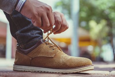 Low section of man wearing shoes