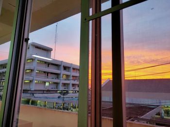 Reflection of sky on glass window during sunset