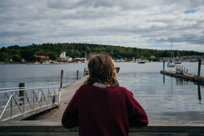 Rear view of woman looking at sea against sky