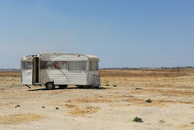 Motor home on field against clear sky