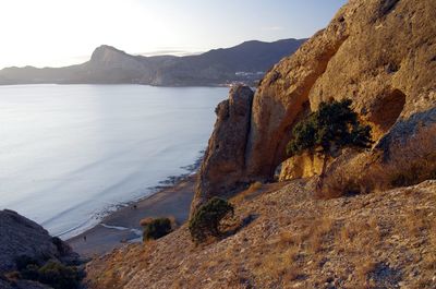 Scenic view of sea and mountains against sky