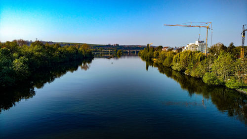 Scenic view of lake against clear blue sky